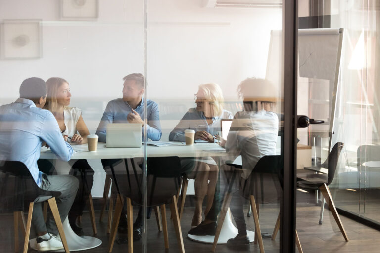 a view of employees around a conference table