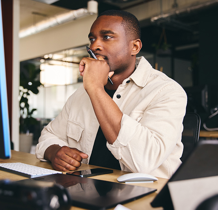 a man concentrating in front of a computer