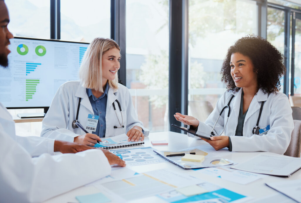 Meeting with three healthcare professionals in front of a monitor