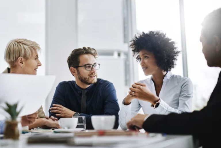 Shot of a diverse group of businesspeople sitting together in a meeting.