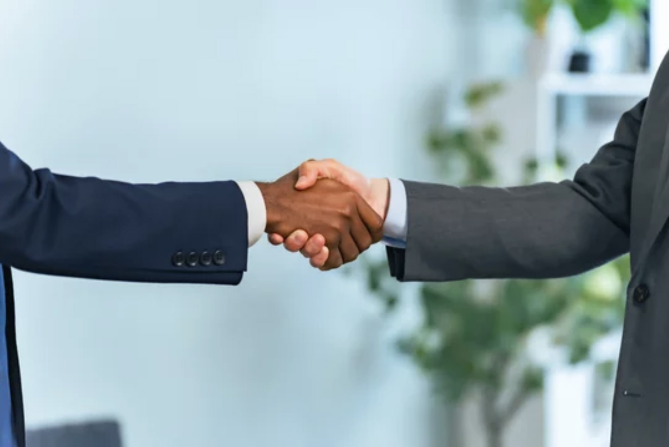 people shaking hands in office, align marketing and sales