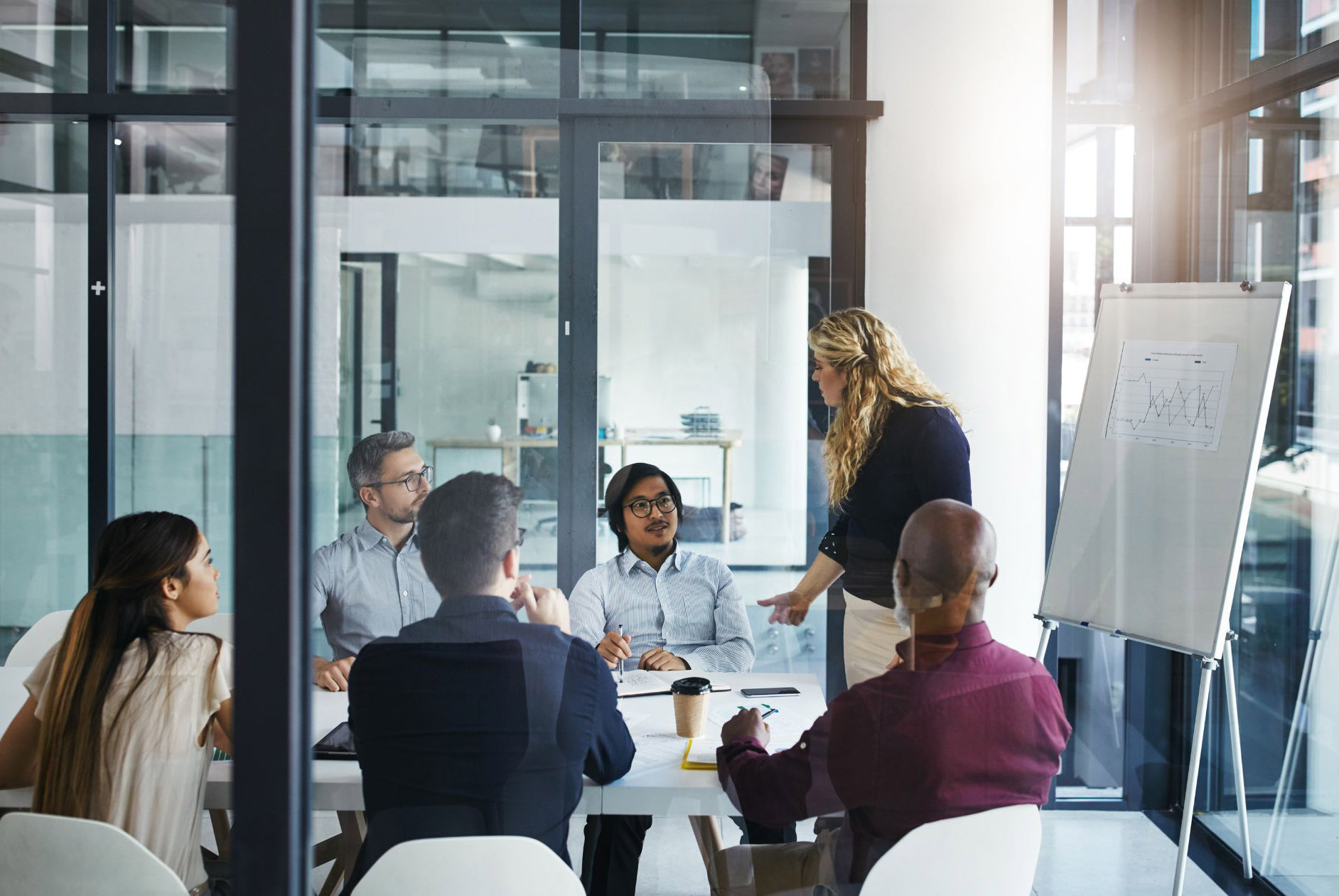 a group of people sitting around a table in an office