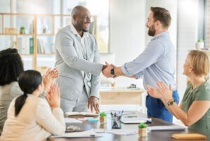 business people shaking hands at a meeting to align marketing and sales